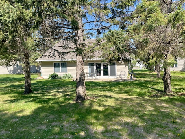 back of house with a yard