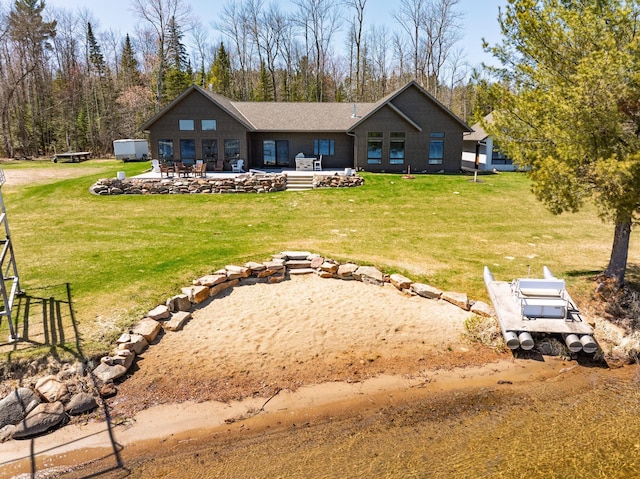 back of house with a yard and a patio