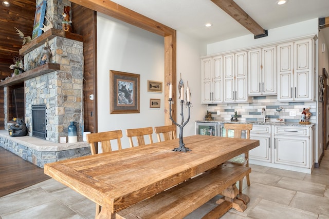 dining area featuring beamed ceiling and recessed lighting