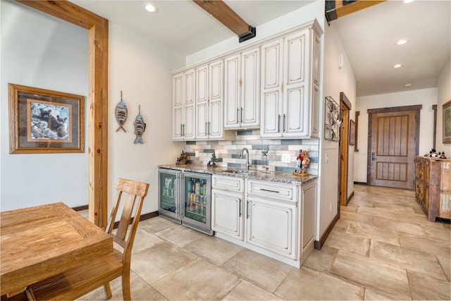 bar featuring a sink, recessed lighting, tasteful backsplash, and beverage cooler