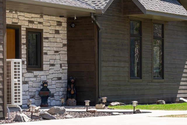 view of side of property with stone siding