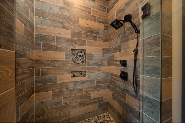 bathroom with tiled shower