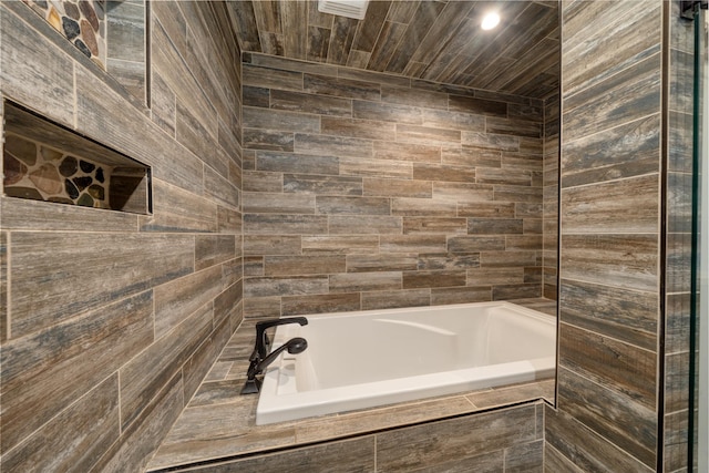 bathroom featuring a relaxing tiled tub and walk in shower