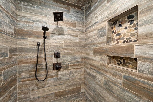 full bath with a tile shower