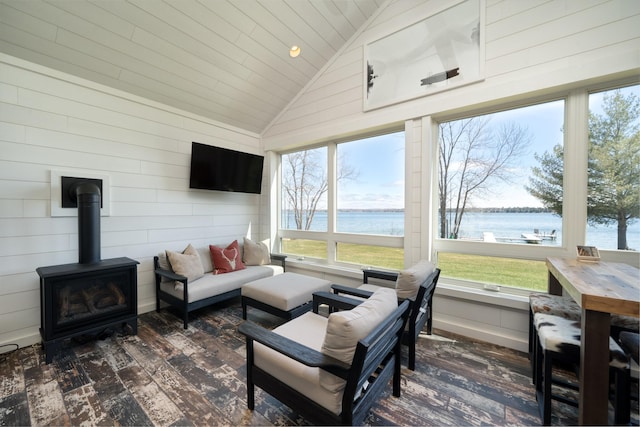 sunroom / solarium featuring a wealth of natural light and a wood stove