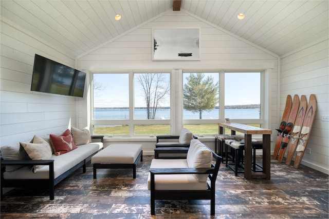 sunroom / solarium featuring a water view