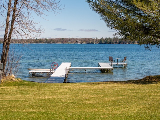 view of dock featuring a yard and a water view