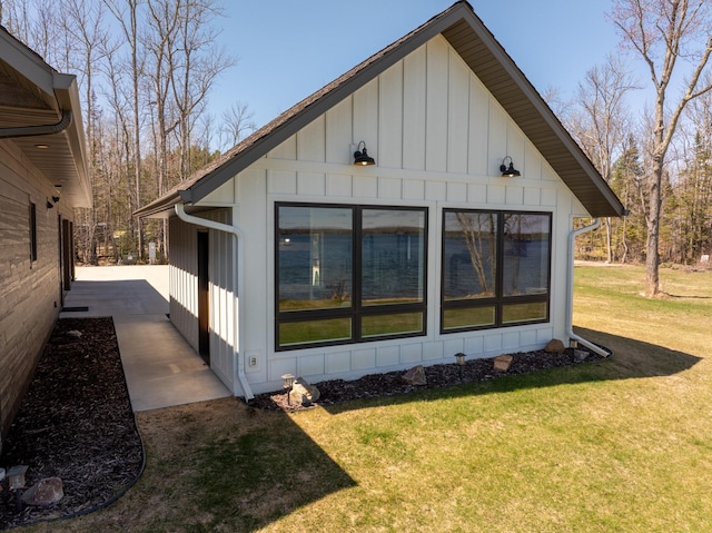 view of property exterior featuring a yard and board and batten siding
