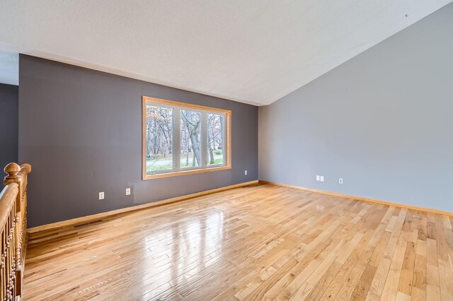 empty room with light wood-type flooring and baseboards