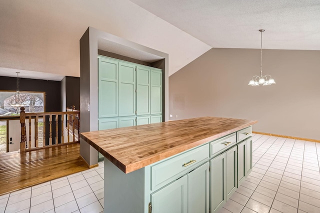 kitchen with light tile patterned floors, decorative light fixtures, butcher block counters, and a chandelier