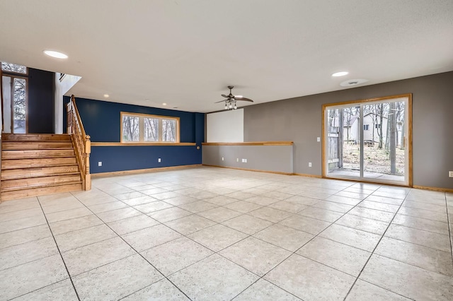 unfurnished living room featuring a healthy amount of sunlight, stairway, recessed lighting, and light tile patterned flooring
