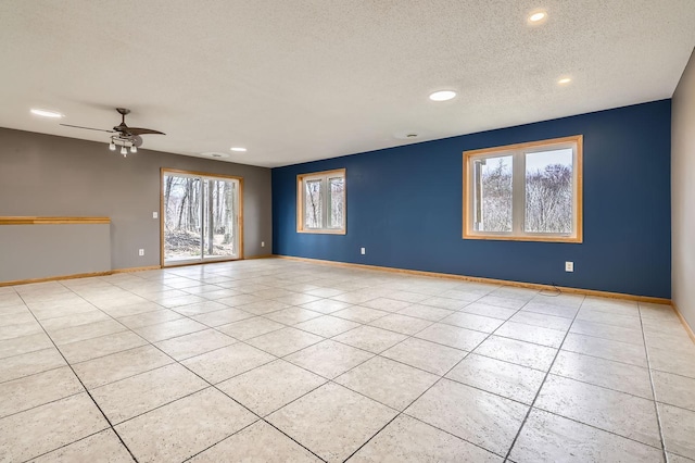 tiled empty room with recessed lighting, a textured ceiling, ceiling fan, and baseboards