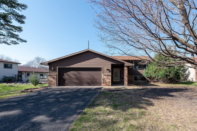 1540 Peggy Ln, North Mankato, MN 56003 - tri-level home with a garage, brick siding, and aphalt driveway