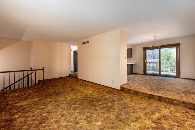 1540 Peggy Ln, North Mankato, MN 56003 - unfurnished living room with a chandelier, visible vents, carpet, and baseboards