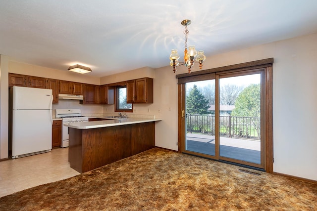 1540 Peggy Ln, North Mankato, MN 56003 - kitchen with white appliances, a chandelier, under cabinet range hood, baseboards, and a peninsula