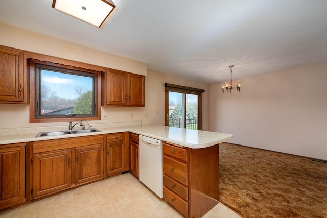 1540 Peggy Ln, North Mankato, MN 56003 - kitchen featuring a sink, light countertops, dishwasher, a peninsula, and brown cabinetry