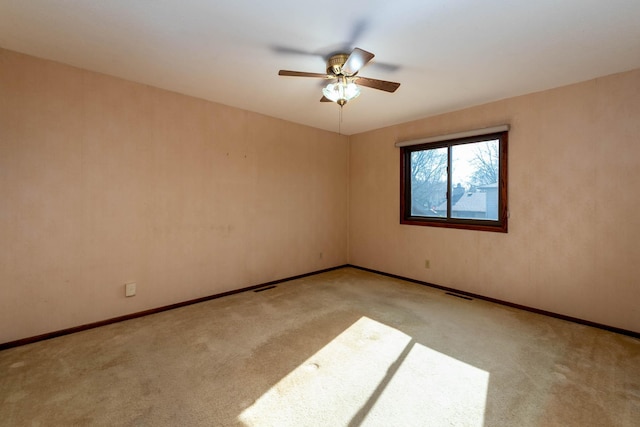 1540 Peggy Ln, North Mankato, MN 56003 - carpeted spare room with baseboards, visible vents, and a ceiling fan