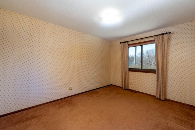 1540 Peggy Ln, North Mankato, MN 56003 - unfurnished room featuring baseboards, wallpapered walls, visible vents, and light colored carpet