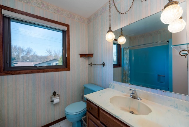 1540 Peggy Ln, North Mankato, MN 56003 - full bathroom featuring tile patterned flooring, wallpapered walls, toilet, vanity, and curtained shower