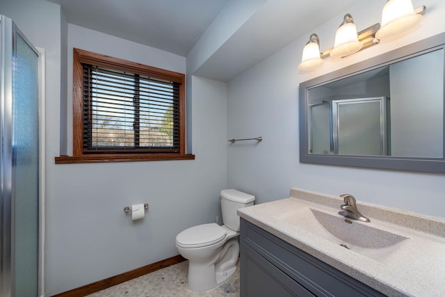 1540 Peggy Ln, North Mankato, MN 56003 - bathroom featuring toilet, a stall shower, vanity, and baseboards
