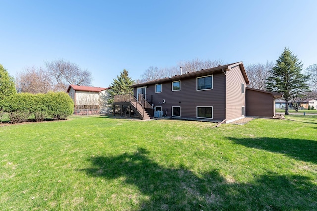 1540 Peggy Ln, North Mankato, MN 56003 - back of property featuring stairway, a wooden deck, and a lawn