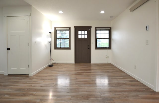 foyer entrance with light wood-style floors, recessed lighting, and a wealth of natural light