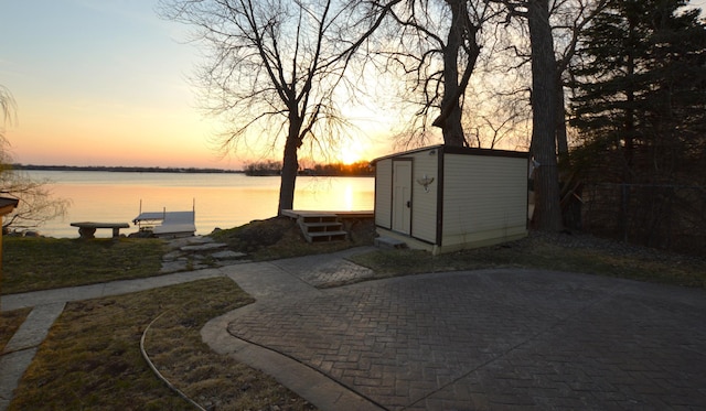 exterior space with fence and a water view
