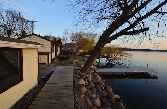 dock area featuring a deck with water view