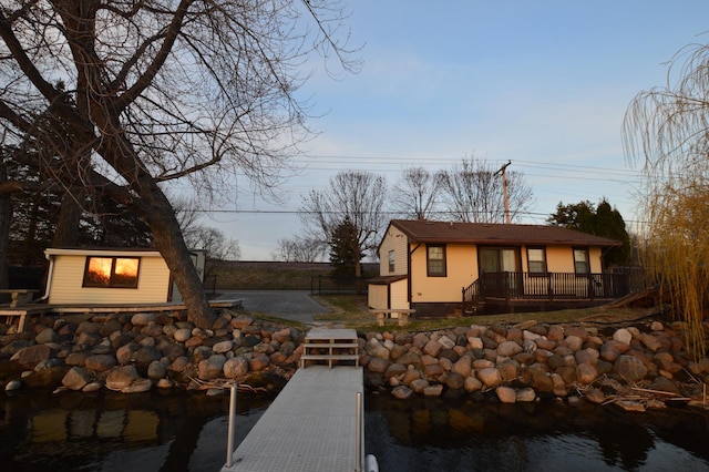 view of dock with a deck with water view