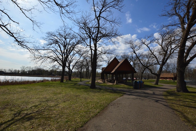 view of property's community featuring a lawn, a water view, and a gazebo