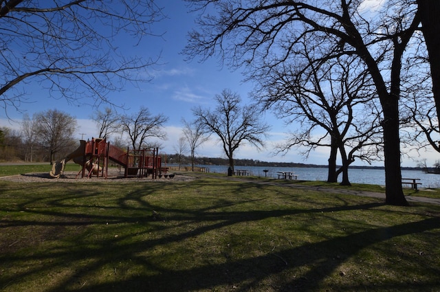 view of yard with a water view and playground community