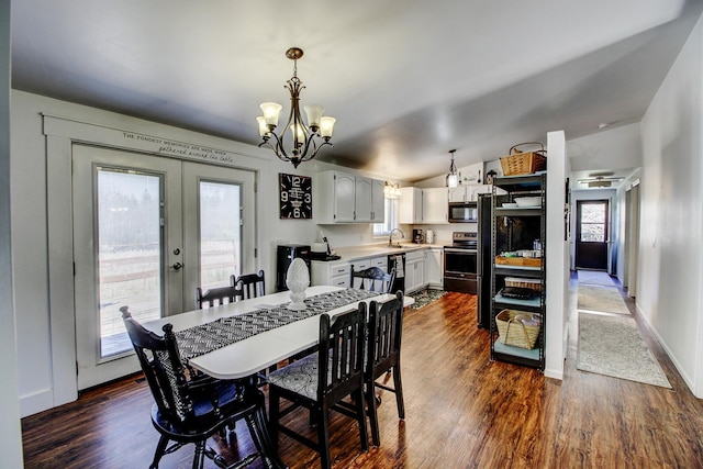 32290 US-71, Menahga, MN 56464 - dining area featuring french doors, dark wood-type flooring, a chandelier, lofted ceiling, and baseboards