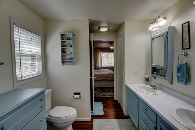 32290 US-71, Menahga, MN 56464 - ensuite bathroom featuring wood finished floors, double vanity, toilet, and baseboards