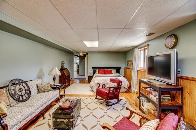 32290 US-71, Menahga, MN 56464 - bedroom featuring wood finished floors, a paneled ceiling, wainscoting, and wood walls