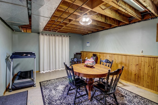32290 US-71, Menahga, MN 56464 - dining room featuring a wainscoted wall, wood walls, baseboards, and concrete floors