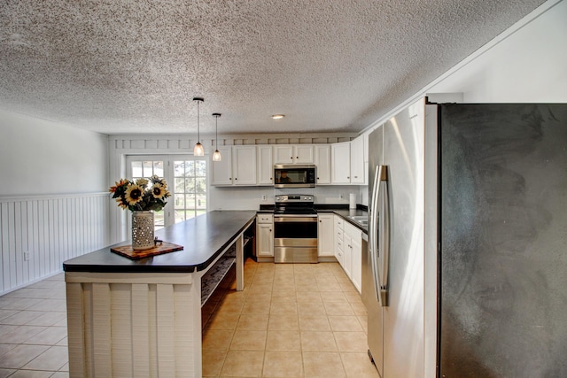 32290 US-71, Menahga, MN 56464 - kitchen with stainless steel appliances, dark countertops, light tile patterned flooring, a textured ceiling, and a kitchen island