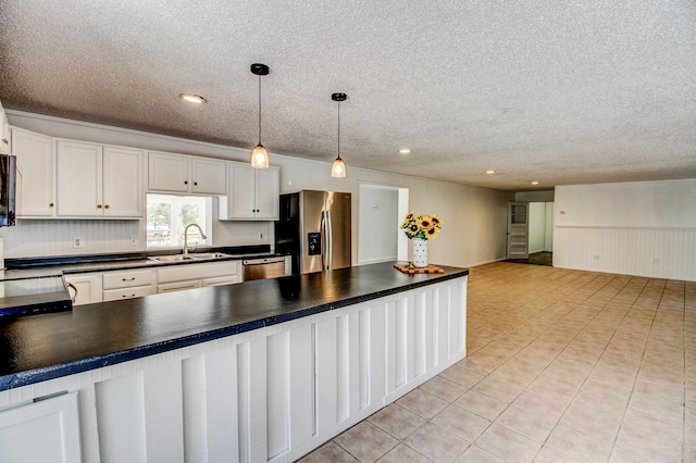 32290 US-71, Menahga, MN 56464 - kitchen with stainless steel fridge, a sink, dark countertops, a textured ceiling, and dishwasher