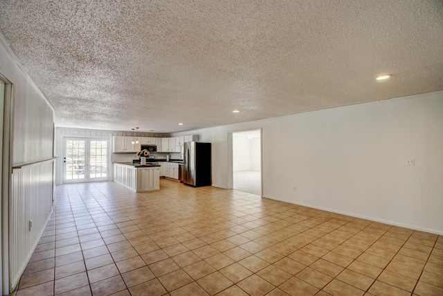 32290 US-71, Menahga, MN 56464 - unfurnished living room featuring a textured ceiling, light tile patterned floors, and recessed lighting