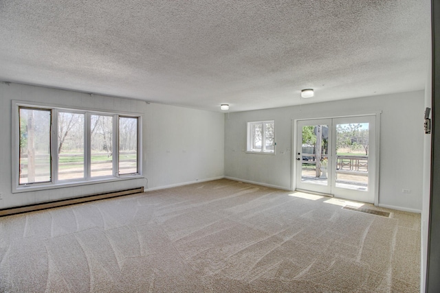 32290 US-71, Menahga, MN 56464 - spare room featuring a baseboard heating unit, carpet flooring, baseboards, and a textured ceiling