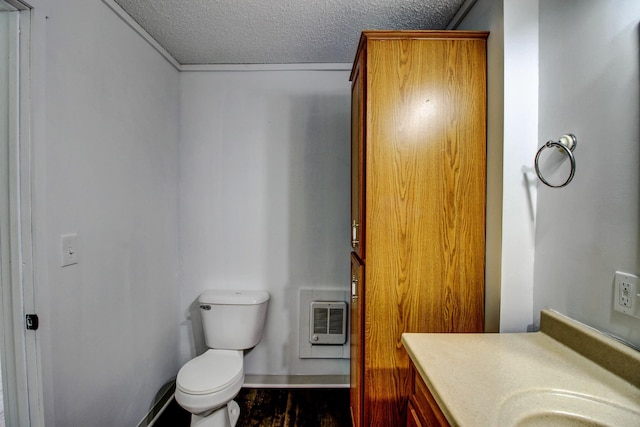 32290 US-71, Menahga, MN 56464 - half bath featuring a textured ceiling, toilet, wood finished floors, vanity, and heating unit