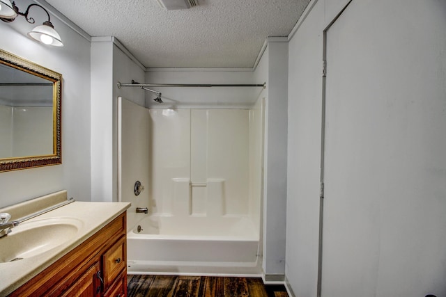 32290 US-71, Menahga, MN 56464 - full bath with a textured ceiling, vanity, wood finished floors, and bathtub / shower combination