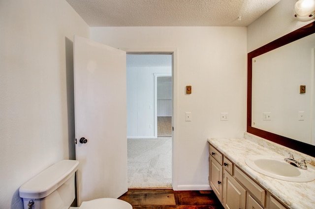 32290 US-71, Menahga, MN 56464 - bathroom with vanity, toilet, wood finished floors, and a textured ceiling