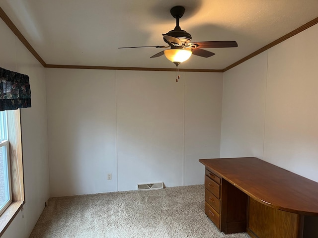 unfurnished office featuring crown molding, a ceiling fan, carpet, and visible vents