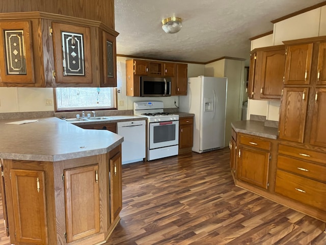 kitchen featuring crown molding, brown cabinets, and white appliances