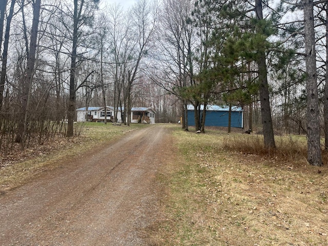 view of street with dirt driveway