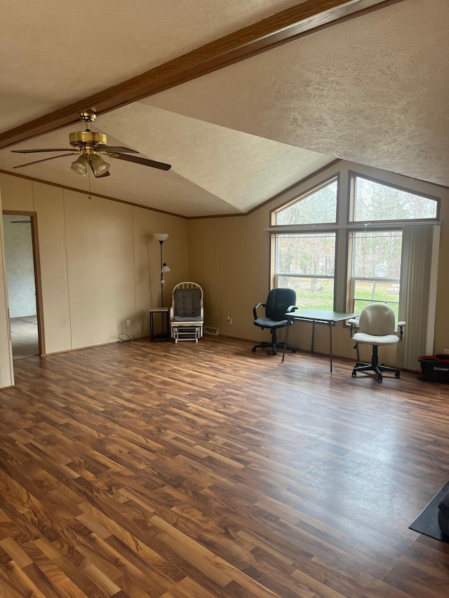 living area featuring lofted ceiling with beams, a textured ceiling, a ceiling fan, and wood finished floors