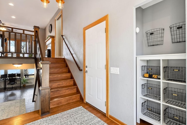 staircase featuring baseboards, recessed lighting, and wood finished floors
