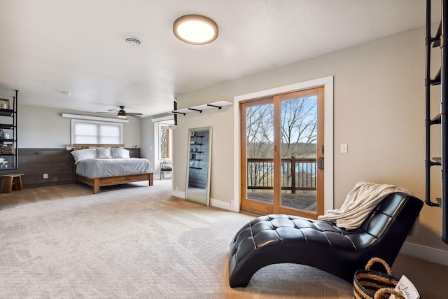 carpeted bedroom featuring access to outside, baseboards, and multiple windows