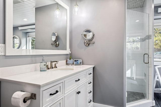 full bath with vanity, a stall shower, and visible vents
