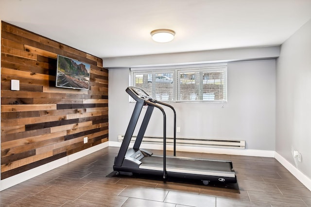 workout room with baseboards and wooden walls